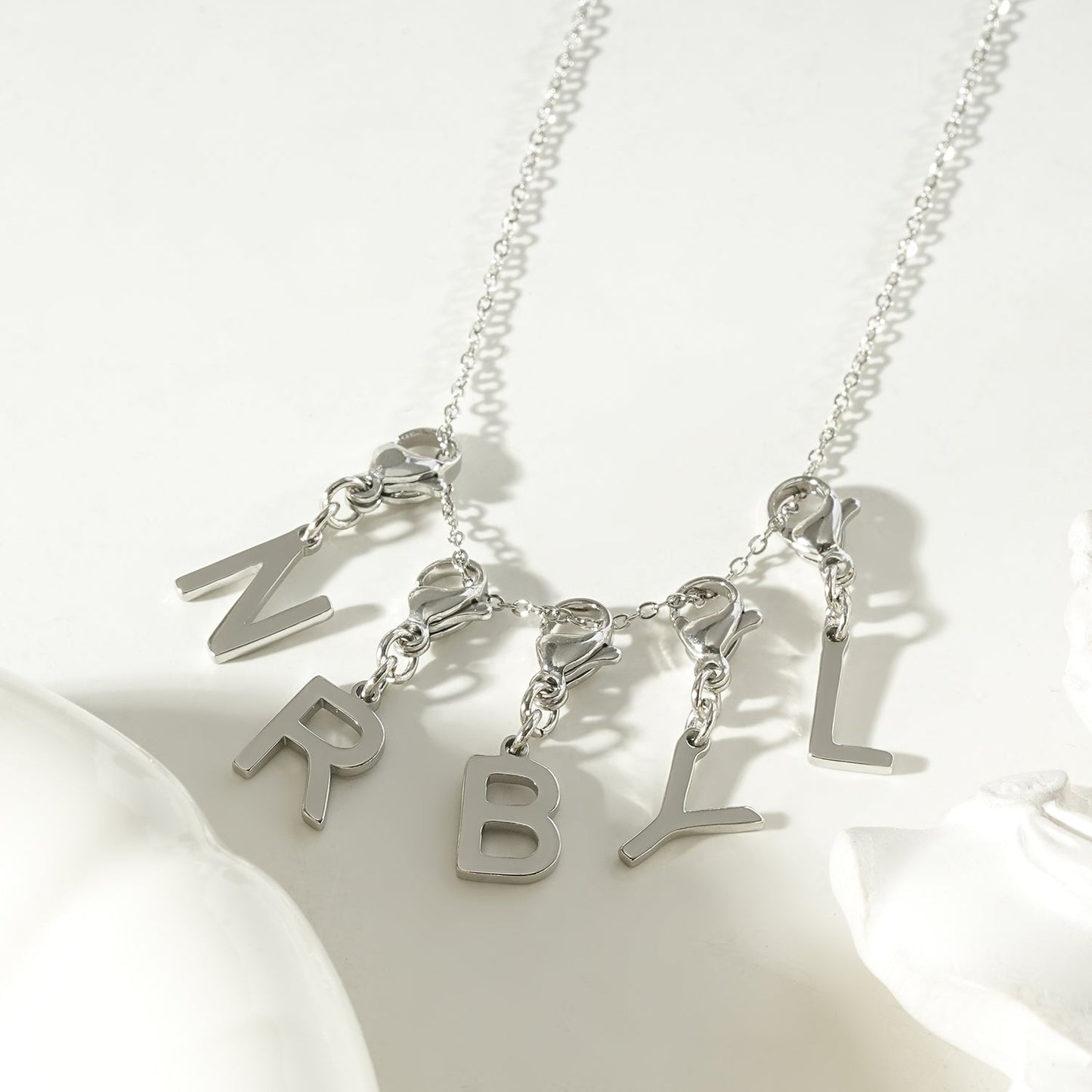 SOLID LETTER MINI CHARMS A–Z in SILVER (White Gold): Dainty Initial Alphabet Pendant for Necklaces & Bracelets — $12.50