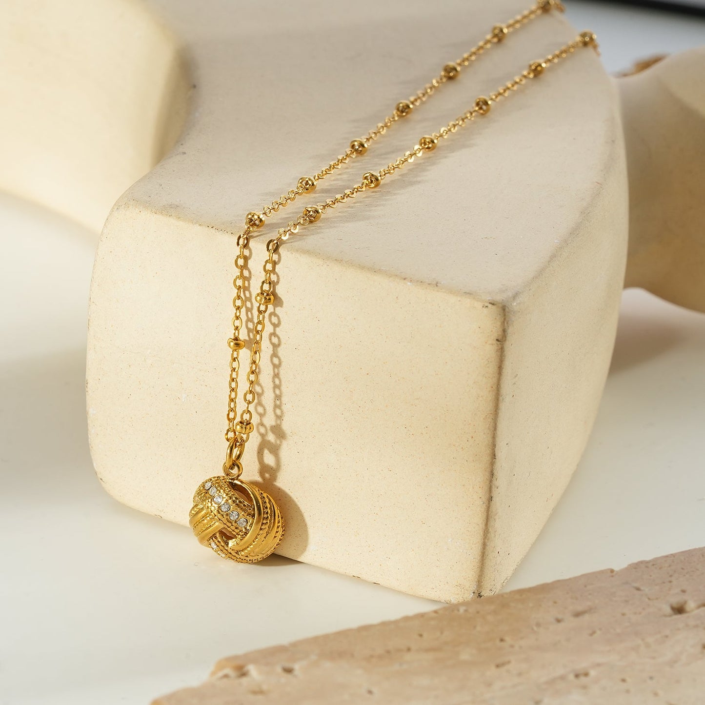 SALAMASINA Gold: Crystal Interwoven Knot Pendant Necklace